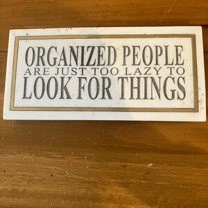 Marble sign with text, “organized people are too lazy to look for things.”